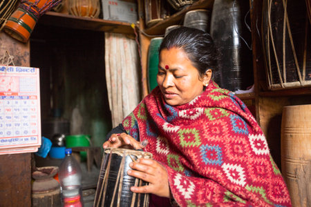 BHAKTAPUR, NEPAL - DEC 19: Unidentified master makes drums in his workshop, Dec 19, 2013 in...