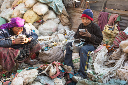 KATHMANDU, NEPAL - DEC 22, 2013: Unidentified people from poorer areas working in sorting of plastic...