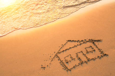 House painted on beach sand.の写真素材