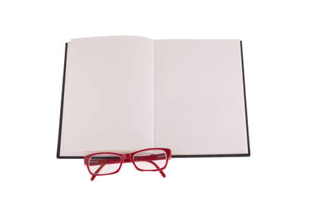 Red glasses placed on notebook, isolated on white background