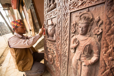 BHAKTAPUR, NEPAL - DEC 19: Unidentified Nepalese man working in the his wood workshop, Dec 19, 2013 in Bhaktapur, Nepal. 100 cultural groups have created an image Bhaktapur as Capital of Nepal Arts.のeditorial素材
