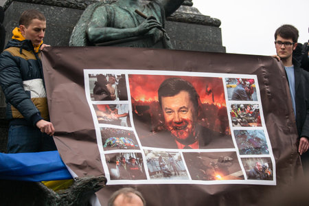 KRAKOW, POLAND - FEB 22, 2014: Unidentified participants during demonstration on Main Square, in support of Independence Ukrainein and against the killing of protesters in Kiev. のeditorial素材