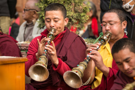 KHATMANDU, NEPAL - DEC 17, 2013: Unidentified tibetan Buddhist monks near stupa Boudhanath during festive Puja of H.H. Drubwang Padma Norbu Rinpoche's reincarnation's.のeditorial素材