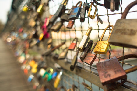 KRAKOW, POLAND - APR 8, 2014: Kladka Bernatka bridge of love with love padlocks. Footbridge Ojca Bernatka - bridge over the Vistula River. Bridge is 145 meters /700 tons.のeditorial素材