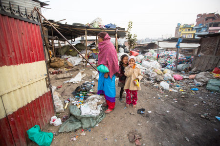 KATHMANDU, NEPAL - DEC 19, 2013: Unidentified children and parents are working on dump. In Nepal...