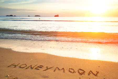 Honeymoon the inscription on the beach sand.の写真素材