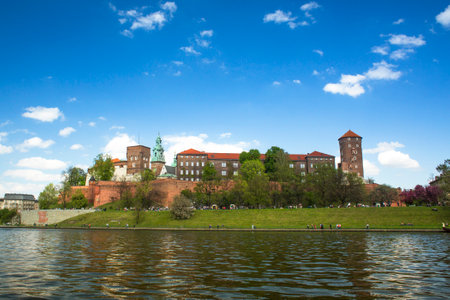 KRAKOW, POLAND - APR 21, 2014: View of Royal Wawel castle with park. The monument to the history of the Decree of the President Lech Walesa on Sep 8, 1994.のeditorial素材