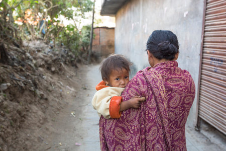 KATHMANDU, NEPAL - DEC 22, 2013: Unidentified local child near their homes in a poor area of the city. The caste system is still intact today but the rules are not as rigid as they were in the pastのeditorial素材