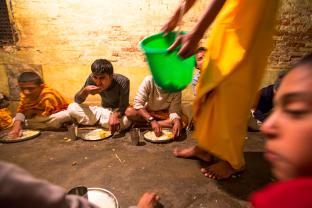 KATHMANDU, NEPAL - DEC 9, 2013: Unknown children during dinner at Jagadguru School. School established at 2013, to let new generation learn Sanskrit and preserve Hindu culture.のeditorial素材