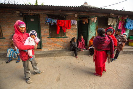 KATHMANDU, NEPAL - DEC 19, 2013: Unidentified local people near their homes in a poor area of the city. The caste system is still intact today but the rules are not as rigid as they were in the past.のeditorial素材