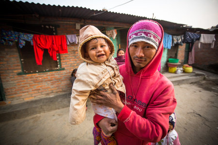 KATHMANDU, NEPAL - DEC 19, 2013: Unidentified local children near their homes in a poor area of the city. The caste system is still intact today but the rules are not as rigid as they were in the past.のeditorial素材
