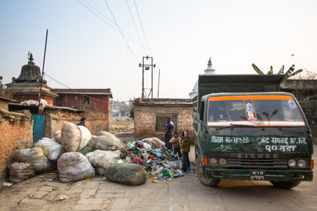KATHMANDU, NEPAL - DEC 19, 2013: Unidentified people from poorer areas working in sorting of plastic on the dump. Only 35% of population have access to adequate sanitation.のeditorial素材