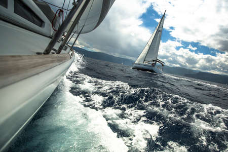 Sailing ship yachts in the sea at race in stormy weather.
