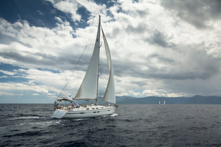 AEGEAN SEA, GREECE - MAY 5, 2014: Unidentified sailboats participate in sailing regatta "11th Ellada 2014" on Aegean Sea.のeditorial素材