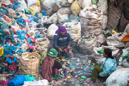 KATHMANDU, NEPAL - DEC 19: Unidentified people from poorer areas working in sorting of plastic on the dump, Dec 19, 2013 in Kathmandu, Nepal. Only 35% of population have access to adequate sanitation.のeditorial素材