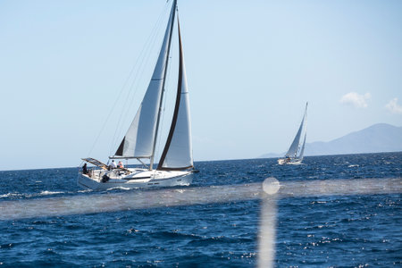 AEGEAN SEA, GREECE - APR 29, 2014: Unidentified sailboats participate in sailing regatta "11th Ellada 2014" on Aegean Sea.のeditorial素材