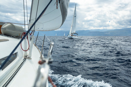 AEGEAN SEA, GREECE - MAY 5, 2014: Unidentified sailboats participate in sailing regatta "11th Ellada 2014" on Aegean Sea.のeditorial素材