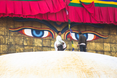 KHATMANDU, NEPAL - DEC 17: Unidentified workers on the stupa Boudhanath during festive solemn Puja of H.H. Drubwang Padma Norbu Rinpoche's reincarnation's, Dec 17, 2013 in Khatmandu, Nepal.のeditorial素材