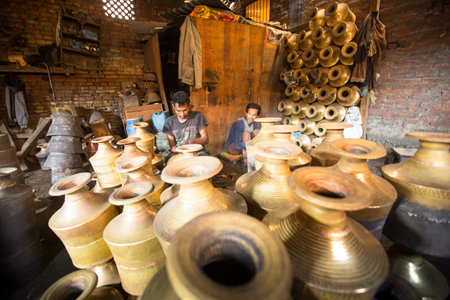BHAKTAPUR, NEPAL - DEC 5: Unidentified Nepalese tinmans working in the his workshop, Dec 5, 2013 in Bhaktapur, Nepal. 100 cultural groups have created an image Bhaktapur as Capital of Nepal Arts.のeditorial素材