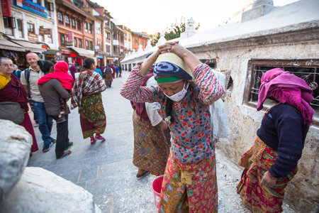 KATHMANDU, NEPAL - DEC 3: Unidentified workers repairing of Stupa Boudhanath, Dec 3, 2013 in Kathmandu, Nepal. Stupa is one of the largest in the world, of 1979 is a UNESCO World Heritage Site.のeditorial素材