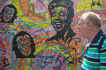 BERLIN, GERMANY - MAY 23, 2014: Fragment of graffiti on Berlin Wall at East Side Gallery - it's a...