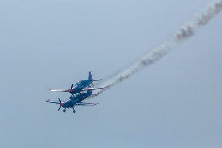 BERLIN, GERMANY - MAY 21, 2014: Two Extra-300, D-EAXK - aerobatic planes (Germany), demonstration...