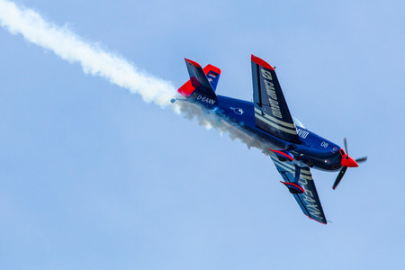 BERLIN, GERMANY - MAY 21, 2014: A Extra-300, D-EAXK- two-seat aerobatic plane (Germany), demonstration during the International Aerospace Exhibition ILA Berlin Air Show-2014.のeditorial素材