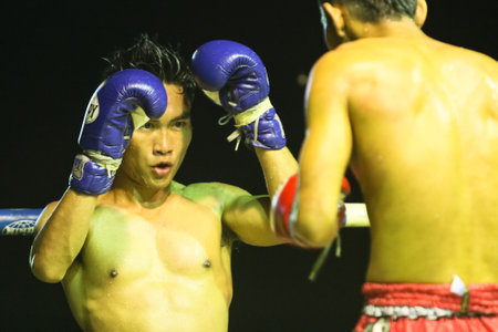CHANG, THAILAND - FEB 22: Unidentified Muay Thai fighters compete in an amateur kickboxing match, Feb 22, 2013 on Chang, Thailand. Muay Thai practiced over 120000 fans and nearly 10000 professionals.のeditorial素材