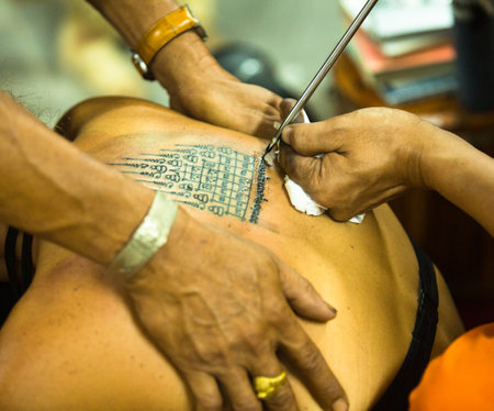 NAKHON CHAI, THAILAND - MAR 1: Unidentified monk makes traditional Yantra tattooing on Mar 1, 2012 in Nakhon Chai, Thailand. Yantra tattoo also called Sak Yant, practiced in Southeast Asian countries.のeditorial素材