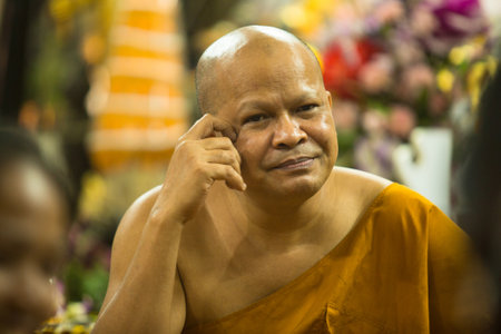 NAKHON CHAI, THAILAND - MAR 1: Unidentified monk master Yantra Tattoos at Wat Bang Phra Buddhist Temple on Mar 1, 2012 in Nakhon Chai, Thailand. Yantra widely practiced in Southeast Asian.のeditorial素材