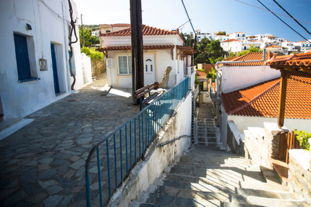 ANDROS, GREECE - APR 29, 2014: Street of Andros, is the northernmost island of the Greek Cyclades archipelago in the Aegean Sea - area is 380 km2, 40 km long, and its greatest breadth is 16 km.のeditorial素材