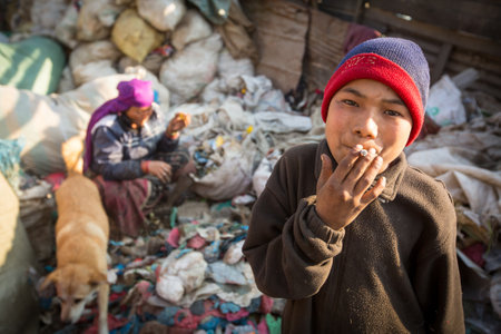 KATHMANDU, NEPAL - DEC 22, 2013: Unidentified people from poorer areas working in sorting of plastic...