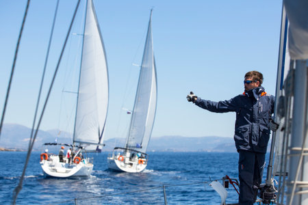 AEGEAN SEA, GREECE - MAY 8, 2014: Unidentified sailboats participate in sailing regatta "11th Ellada 2014" on Aegean Sea.のeditorial素材