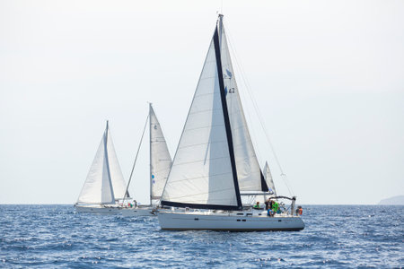 AEGEAN SEA, GREECE - APR 27, 2014: Unidentified sailboats participate in sailing regatta "11th Ellada 2014" on Aegean Sea.のeditorial素材