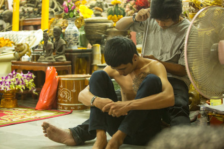 NAKHON CHAI, THAILAND - MAR 1: Unidentified monk makes traditional Yantra tattooing on Mar 1, 2012 in Nakhon Chai, Thailand. Yantra tattoo also called Sak Yant, practiced in Southeast Asian countries.のeditorial素材