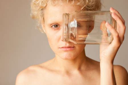 Abstract picture - the girl looks through the empty jar.の写真素材