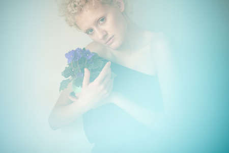 Young sexy romantic girl in blur with flowers in their hands.の写真素材