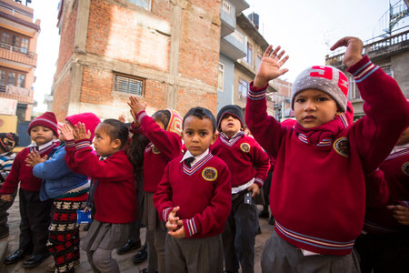 KATHMANDU, NEPAL - DEC 22, 2013: Unknown pupils during dance lesson in primary school. Only only 25% of girls attend schools and half of the children can reach the 5 grade.のeditorial素材