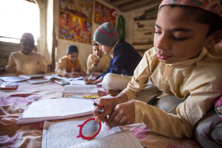 KATHMANDU, NEPAL - DEC 9, 2013: Unknown children doing homework at Jagadguru School. School...