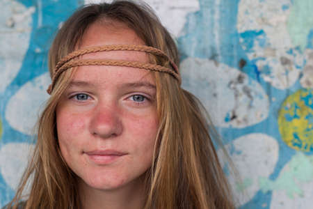 Closeup portrait of young girl hippie, dirty background (concept 70s)の写真素材