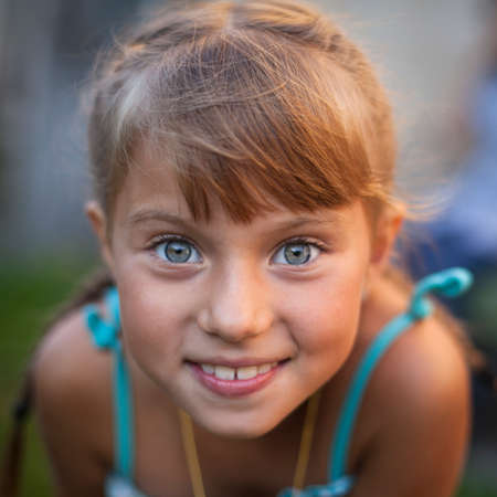 Close-up portrait of a cheerful little cute girl.の写真素材