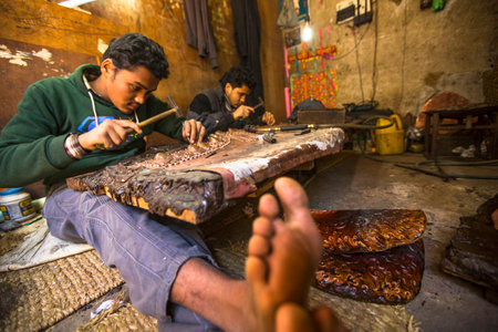 BHAKTAPUR, NEPAL - DEC 5, 2013: Unidentified Nepalese tinman working in the his workshop. More 100 cultural groups have created an image Bhaktapur as Capital of Nepal Arts.のeditorial素材