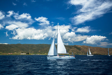 METHANA - POROS - ERMIONI, GREECE - MAY 4, 2014: Unidentified sailboats participate in sailing regatta "11th Ellada Spring 2014" on Aegean Sea.のeditorial素材