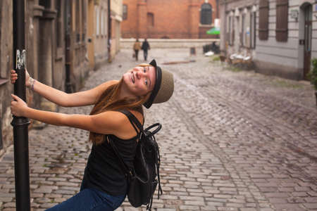 Young happy beautiful girl in the old town. European tour.の写真素材