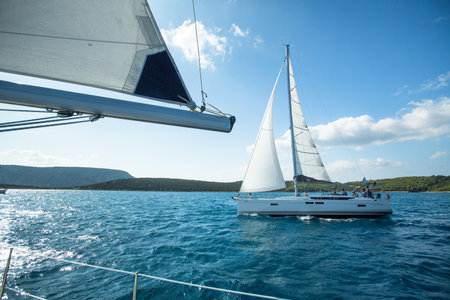 ERMIONI - POROS, GREECE - OCT 9, 2014: Unidentified sailboats participate  in sailing regatta "12th Ellada Autumn 2014" on Aegean Sea.のeditorial素材