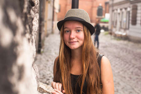 Young pretty girl in the street of the old town.の写真素材