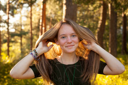 Happy girl in the sunny forest.の写真素材