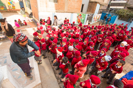 KATHMANDU, NEPAL - DEC 22, 2013: Unknown pupils during dance lesson in primary school. In Nepal only 25% of girls attend schools and half of the children can reach the 5 grade.のeditorial素材