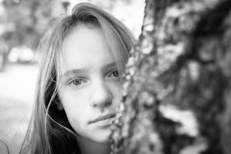 Closeup portrait of young beautiful girls outdoors. Black and white photography.の写真素材
