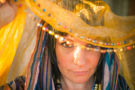 Young woman in a chador in the soft rays of the sun.の写真素材